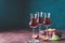 Plums strong alcoholic drink in grappas wineglass with dew. Hard liquor, slivovica, plum brandy or plum vodka with ripe plums on