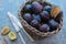 Plums in wooden wicker