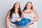 Plus size caucasian sisters woman holding laundry basket looking at the camera blowing a kiss being lovely and sexy