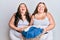 Plus size caucasian sisters woman holding laundry basket smiling and laughing hard out loud because funny crazy joke