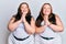 Plus size caucasian sisters woman wearing casual white clothes praying with hands together asking for forgiveness smiling