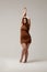 Plus size fashion model in brown short dress