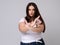 Plus Size Model with long hair gesturing no signal in studio.