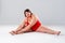 Plus size model in red lingerie, fat woman in underwear on gray background, body positive concept