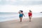 Plus size women walking on the beach having fun during summer vacation - Curvy female laughing together - Overweight body and