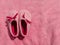 Plush baby's bootees pink velvet fabric texture top view. Smooth soft fluffy velvety satin cloth girly shiny rose female