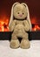 Plush beige Bunny on the background of the fireplace