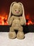 Plush beige Bunny on the background of the fireplace