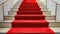 a plush red carpet cascades down the stairs, adorning the interior of a lavish hotel or restaurant, exuding elegance and