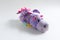Plush soft children`s toy purple dragon with colorful round spots. Turn it inside out.