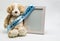 Plush teddy bear and empty picture frame with `It`s A Boy` ribbon
