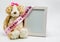 Plush teddy bear and empty picture frame with `It`s A Girl` ribbon