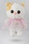 Plush white cat toy. A cat with a red ear