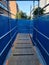 A plywood construction walkway with blue vinyl on the sides