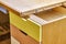 Plywood desk with multi color drawers during assembly. Close-up
