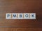 PMBOK in black and white letters on wood background
