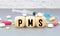 PMS Premenstrual Syndrome acronym on wooden block
