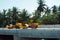 Pneumatic roller compactor at asphalt pavement works for road repairing on a construction site with a palm trees on