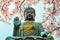 Po Lin Monastery, buddha statue with cherry blossom in Hong Kong