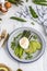 Poached eggs with asparagus, avocado and green peas