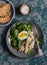 Poached mackerel, spinach and egg salad on a dark background, top view. Delicious healthy food