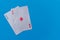 Pocket aces pair hand on bright blue flat lay background for poker, betting and casino concepts