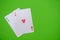 Pocket aces pair hand on bright green flat lay background for poker, betting and casino concepts