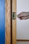 Pocket door by blue wall being unlocked and opened