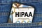 In a pocket of jeans there is a smartphone on the screen of which the text - HIPAA