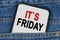 In a pocket of jeans there is a smartphone on the screen of which the text - ITS FRIDAY