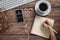 Podcast audio content concept. podcast application on mobile smartphone screen on wooden table with coffee cup, earphones, glasses