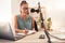 Podcast microphone, laptop and woman writing in notebook for ideas, research or information. Influencer, presenter or
