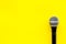 Podcast record with microphone on yellow background top view space for text