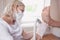 Podiatrist using grinding equipment and making procedure polish for feet pedicure. Podology beautician in white gloves cleaning