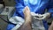 Podiatrist in white gloves clean with cotton a toenail. Concept of podology and chiropody.