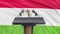 Podium lectern with microphones and Tajik Flag in background