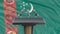 Podium lectern with microphones and Turkmenistan flag in background