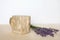 Podium for presentation on wooden table, lavender flowers. Abstract geometrical form. Cylinder wood. Shadow. Scene to