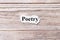 Poetry of the word on paper. concept. Words of poetry on a wooden background