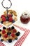 Poffertjes with berries and jelly on a cake stand