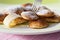 Poffertjes with powdered soft sugar and fork