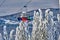 Poiana Brasov, Romania -09 January 2019: Skiers on the ski lift, skiers on slope in Romanian ski resort in sunny day, Poiana