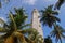 Point Dondra, Lighthouse in Dondra, Sri Lanka. Palm trees and a blue sky.