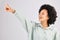 Point, happy and black woman in studio smile with hand gesture for news, announcement and deal. Mockup space, white