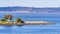 Point San Bruno Park jetty on the shoreline of San Francisco Bay; Port of Oakland, Oakland city skyline and residential