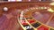 Point of view close-up spinning casino roulette table with roulette ball 3d