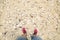 Point of view of feet on a beach