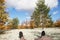 Point of view feet in sneakers in white reindeer lichen in tundra. Man hiker relaxing in wonderful place. Harmony with