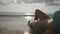 Point of view of girl lying on the beach in the waves. Beautiful young woman relaxing on sea shore during summer