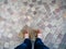 Point of view of leather shoes in ornate rock mosaic floor